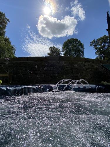 a water fountain in the middle of a park at Ribblesdale Park in Gisburn