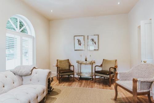 a living room with a white couch and chairs at Ribblesdale Park in Gisburn