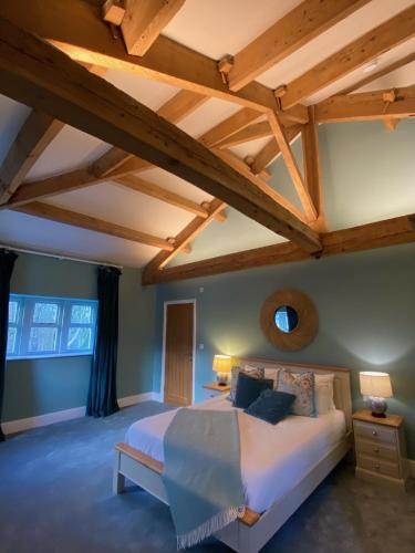 a bedroom with a large bed and wooden ceilings at Ribblesdale Park in Gisburn
