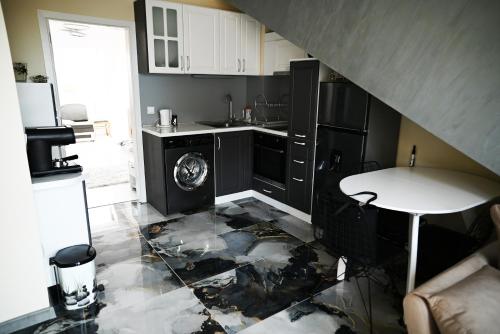 a kitchen with a sink and a washer and dryer at БИСЕР 2023 in Ruse