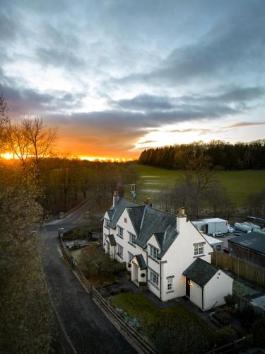 an aerial view of a house with the sunset in the background at Ribblesdale Park in Gisburn