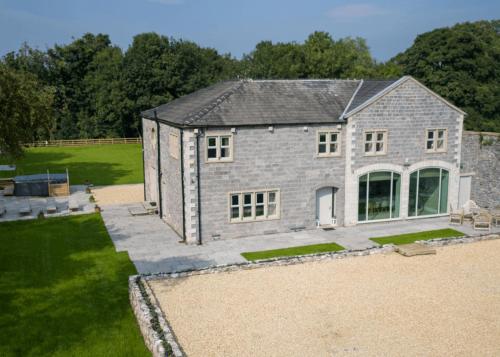 an aerial view of a large stone house at Ribblesdale Park in Gisburn