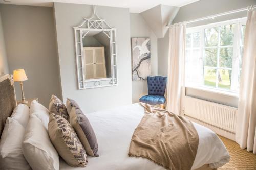 a bedroom with a bed with pillows and a mirror at Ribblesdale Park in Gisburn