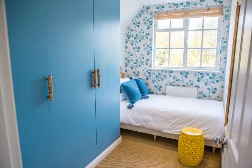 a small bedroom with a bed and a window at Ribblesdale Park in Gisburn