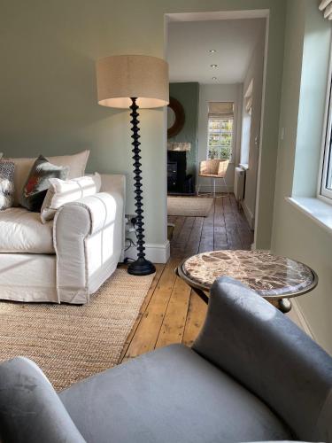 a living room with two white couches and a lamp at Ribblesdale Park in Gisburn