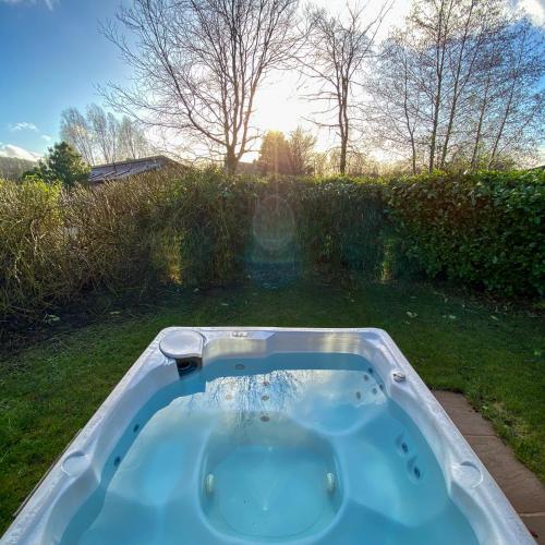 a jacuzzi tub in the yard of a house at Ribblesdale Park in Gisburn