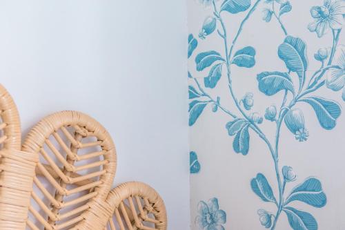 a wall with a floral wallpaper and a chair at Ribblesdale Park in Gisburn