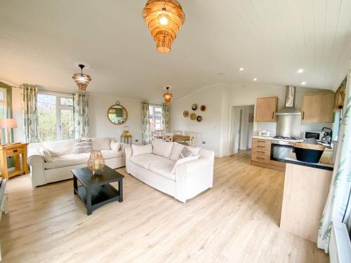 a living room with a couch and a table at Ribblesdale Park in Gisburn
