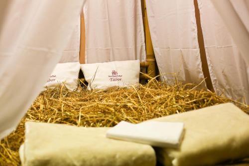 a nest of hay with two white bags in a tent at LH Hotel Dvořák Tábor Congress & Wellness in Tábor