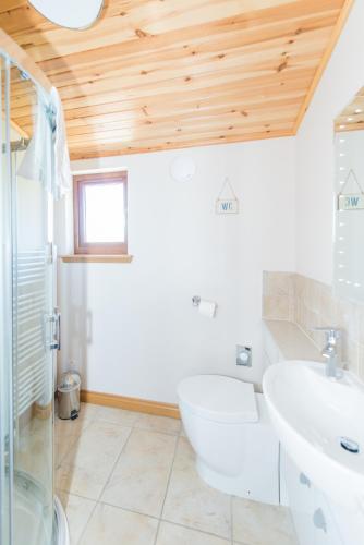 a bathroom with a tub and a sink at Barn Lodge with Hot Tub in Cupar