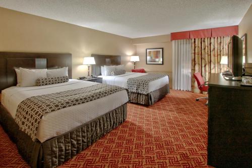 
a hotel room with two beds and two lamps at Alta Hotel in Colorado Springs
