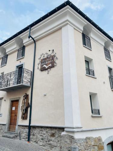 a building with a sign on the side of it at Residenza dell'Aquila - appartamento in Vezza dʼOglio