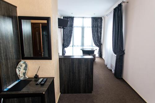 a hotel room with a hallway with a sink and a mirror at Готель Скіфія in Lviv