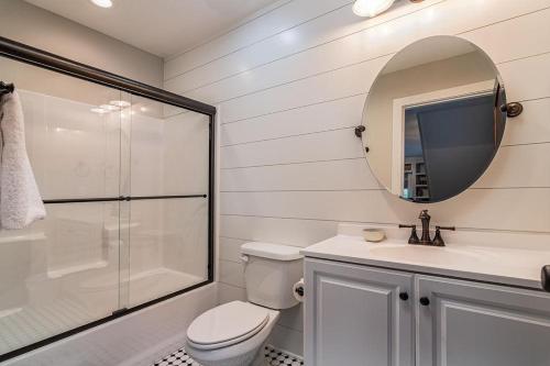 a bathroom with a toilet and a sink and a mirror at Cedarwood Farmstead in Ridgedale