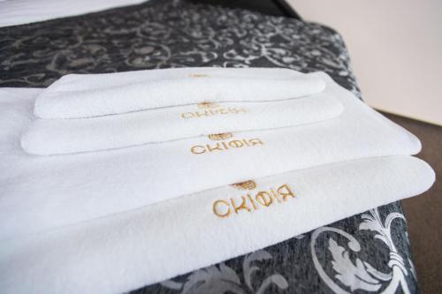 a pile of white towels sitting on a bed at Готель Скіфія in Lviv