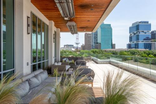 a patio with furniture and a view of the city at Mint House Dallas - Victory Park in Dallas