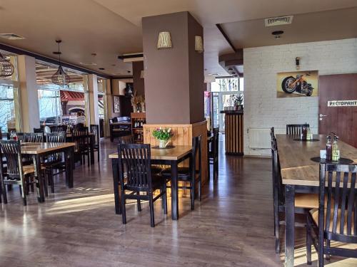 a dining room with tables and chairs in a restaurant at Family Hotel Diana in Tsarevo
