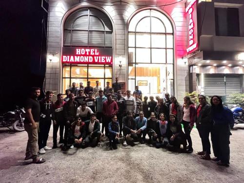 a group of people standing in front of a building at Hotel Diamond View in Amritsar