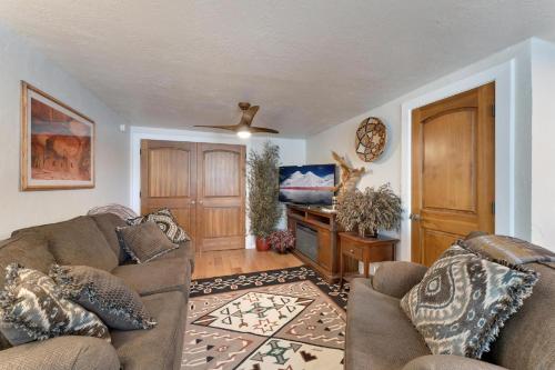 a living room with two couches and a ceiling fan at Stone Lizard Lodge in Blanding