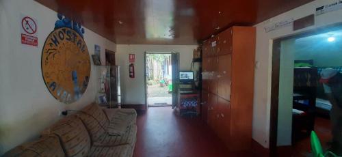 a living room with a couch and a room with a door at Aventura Chachapoyas Backpackers in Chachapoyas