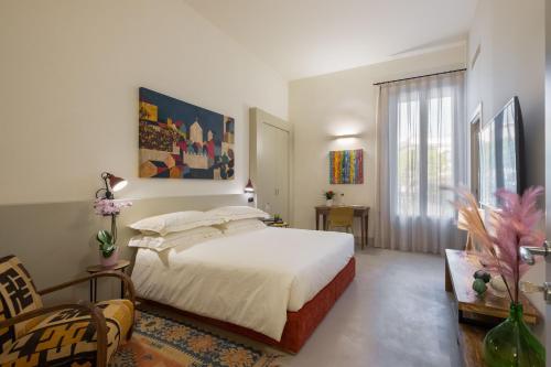 a bedroom with a bed and a large window at Palazzo San Lazzaro - Jacuzzi Rooms & Suites Lecce Selection in Lecce