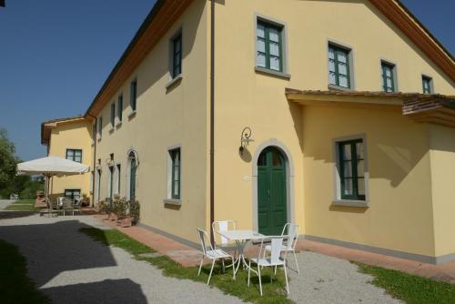 a table and chairs in front of a building at Agriturismo Musignano in Cerreto Guidi