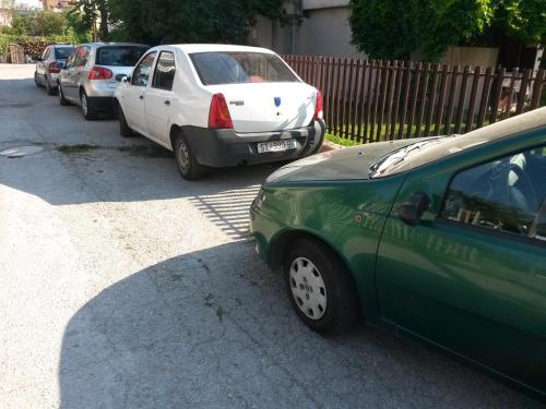 a row of cars parked on the side of a street at Marko Apartments in Struga