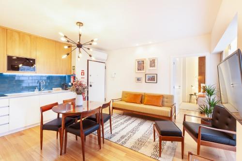 a kitchen and living room with a table and a couch at Avenida Residence in Braga