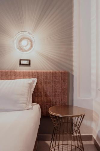 a bedroom with a bed and a table at Hotel Marisa in Rome