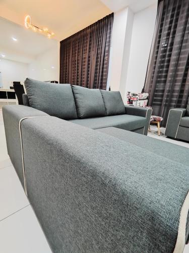 a living room with a couch and a table at Ipoh Lake View Cozy Home Big House in Lahat