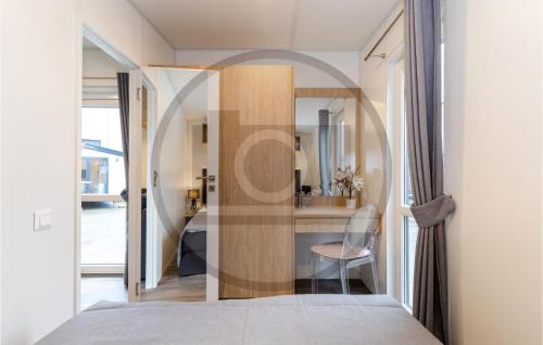 een slaapkamer met een deur naar een keuken met een spiegel bij Tiny Haus 17 Am Brombachsee in Pleinfeld