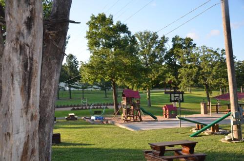 a park with a playground with a table and a tree at Three Bear Lodge in Ridgedale