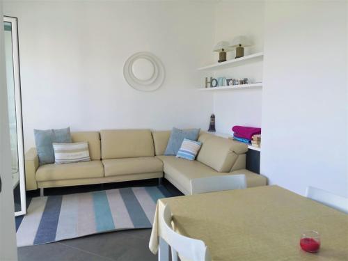 a living room with a couch and a table at Silvia al mare in Diano Marina