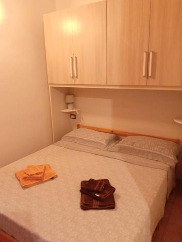 a bedroom with a bed with a purse on it at Bed and Breakfast Stefania in Giulianova