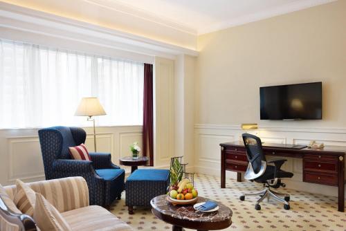 a living room with a couch and a desk at Crowne Plaza Hotel & Suites Landmark Shenzhen by IHG - Nearby Luohu Border, Indoor heated swimming pool, Complimentary Welcome Drink in Shenzhen