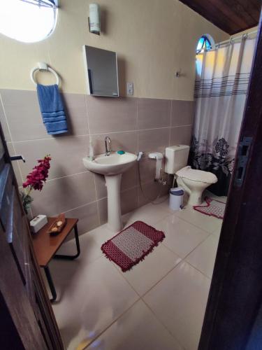 a bathroom with a sink and a toilet at Quinta da Bela Vista in Caeté