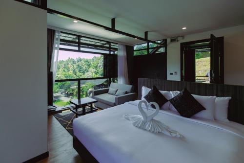 a bedroom with a white bed with a butterfly on it at D’Endless Resotel in Baen