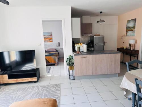 - deux photos d'une cuisine et d'un salon dans l'établissement Charmante maison au calme, à Aigues-Mortes