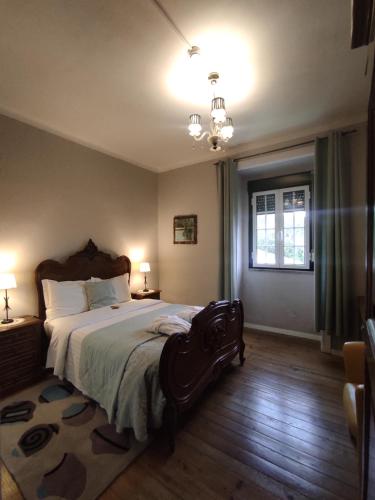 a bedroom with a large bed and a window at Hotel Boavista - Vintage House in Monfortinho