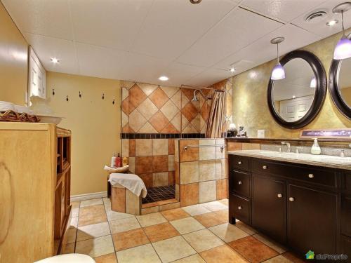 a large bathroom with a shower and a sink at Le Gite Du Hu-Art in Quebec City
