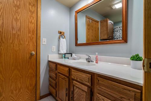 a bathroom with a sink and a mirror at Ozark Outdoor Legacy in Ridgedale