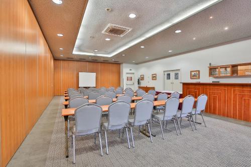 a conference room with a long table and chairs at LH Hotel Dvořák Tábor Congress & Wellness in Tábor