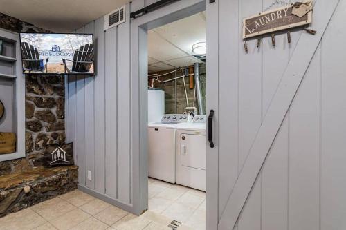 an open door to a kitchen with a washer and dryer at Red Bud Cove Lakefront Farm House on Table Rock Lake in Hollister