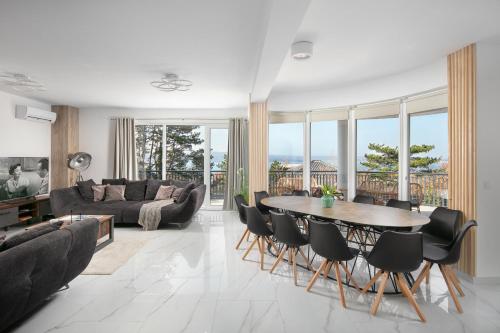a living room with a table and chairs at Villa Chanel in Crikvenica
