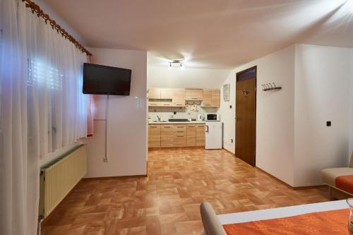 sala de estar con TV y cocina en Apartma Steles, en Stari Trg pri Ložu