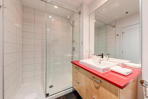 a bathroom with a sink and a shower at Les Immeubles Charlevoix - Le 760-209 in Quebec City