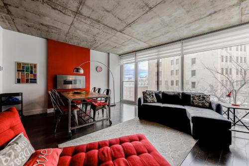 a living room with a couch and a table at Les Immeubles Charlevoix - Le 760-209 in Quebec City