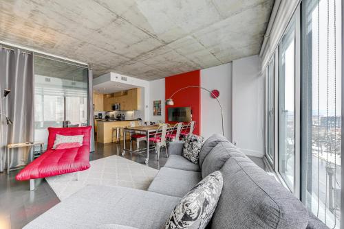 a living room with a couch and a table at Les Immeubles Charlevoix - Le 760-209 in Quebec City