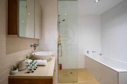 a bathroom with a sink and a shower at ZEN PARADISE - 2-BR Waterfront Ocean View Retreat in Darwin