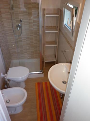 a bathroom with a toilet and a sink and a shower at Appartamenti Piombino Isola d'Elba in Rio Marina